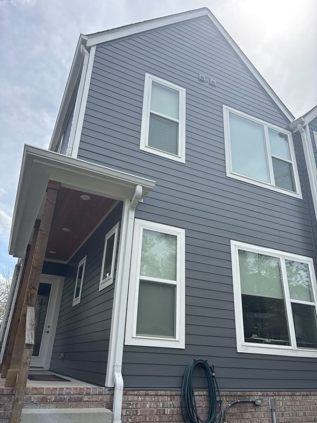 Two-story gray lap-siding townhome with white trim on Rains Ave, Wedgewood-Houston