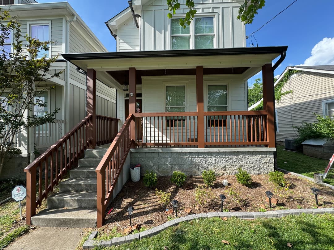 Front porch with freshly painted rails and posts on Tennessee Ave in The Nations