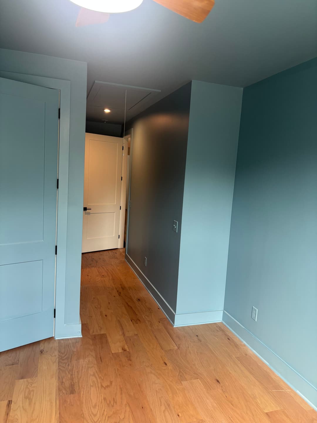 Blue-grey bedroom with a darker accent wall and white doors, Spain Ave, Inglewood